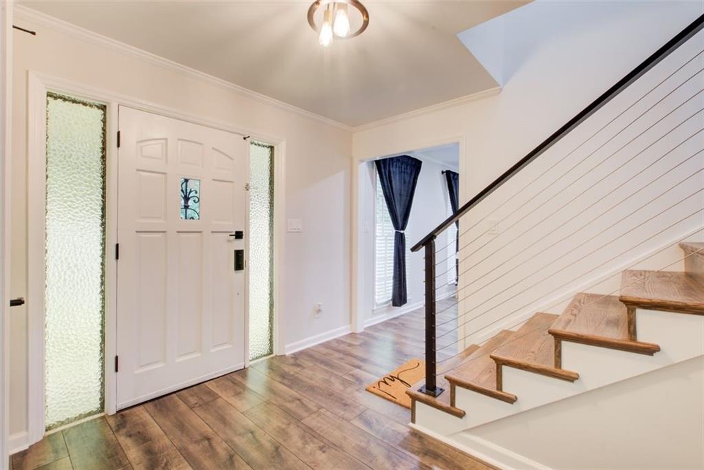 2085 High Point Trail Southwest Atlanta, GA 30331 - Photo 5 of 36 a view of a hallway with wooden floor and staircase