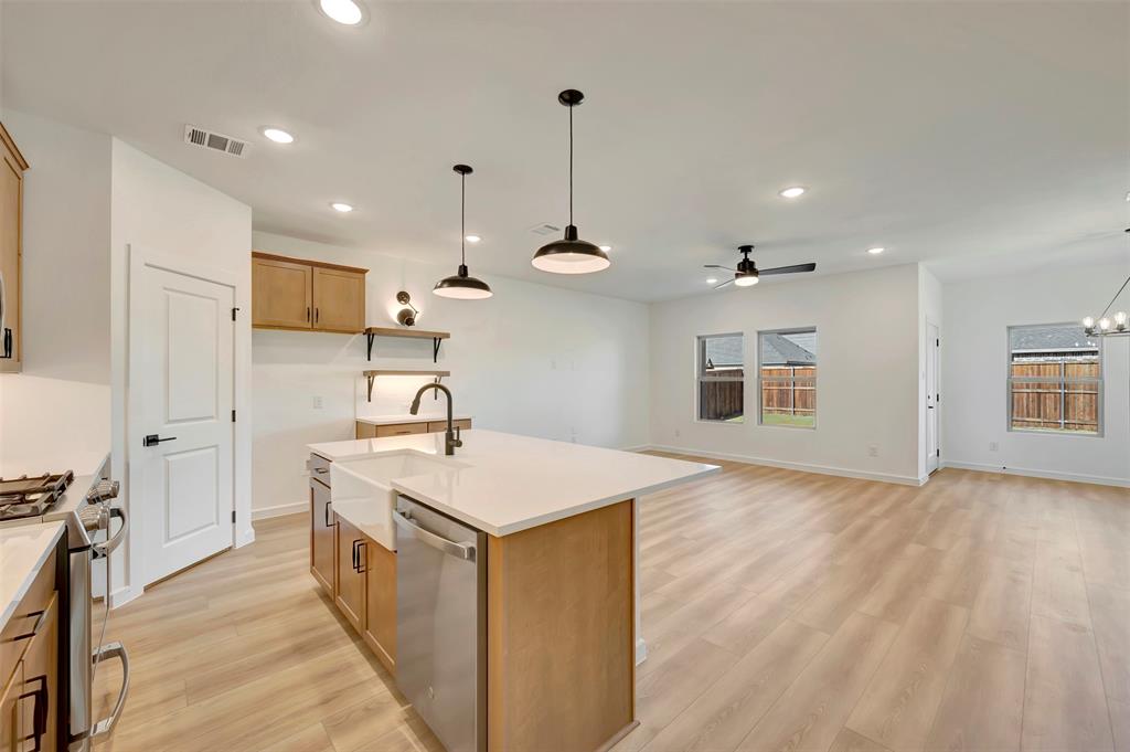 524 Brookside Drive Van Alstyne, TX 75495 - Photo 12 of 32 a kitchen with kitchen island a sink stainless steel appliances and cabinets
