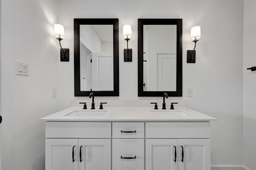 524 Brookside Drive Van Alstyne, TX 75495 - Photo 19 of 32 a bathroom with double vanity sinks and a mirror