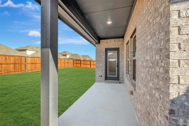 a view of a porch with a big yard and potted plants