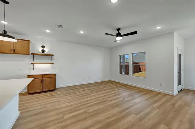 a view of a kitchen with a sink and a ceiling fan