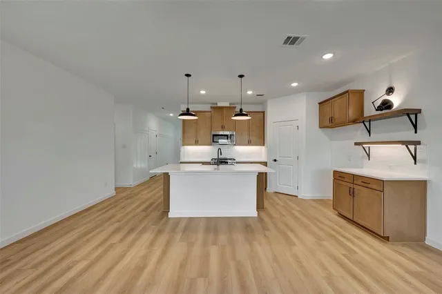 a view of kitchen with sink microwave and stove