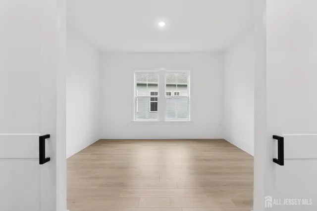 a view of a room with wooden floor and window