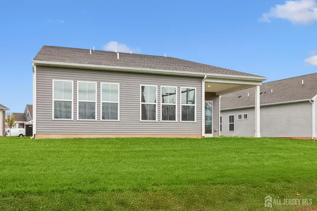 a front view of a house with a garden and yard
