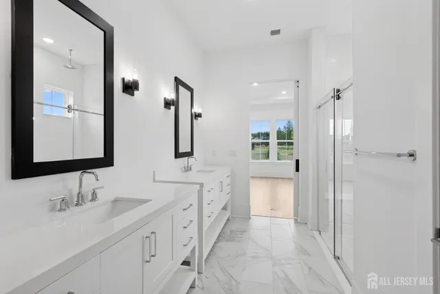 a bathroom with a double vanity sink mirror and double