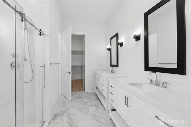 a bathroom with double vanity sinks and a mirror