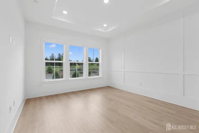 a view of a room with wooden floor and windows