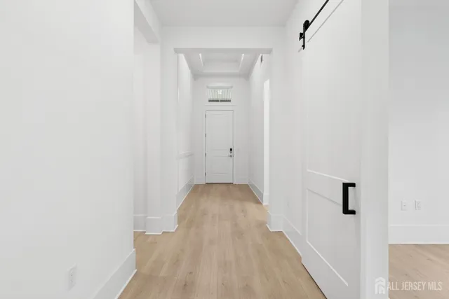 a view of a hallway with wooden floor