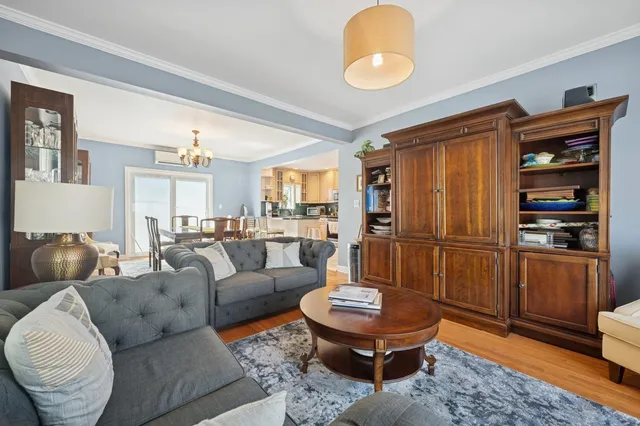 a living room with furniture a rug and kitchen view