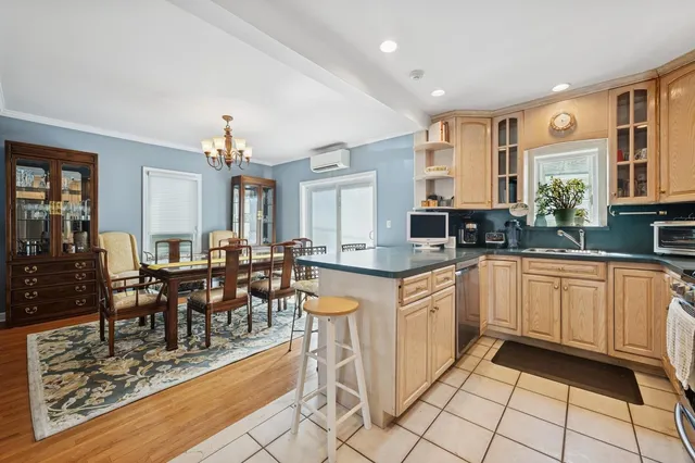 a large kitchen with lots of counter top and dining table