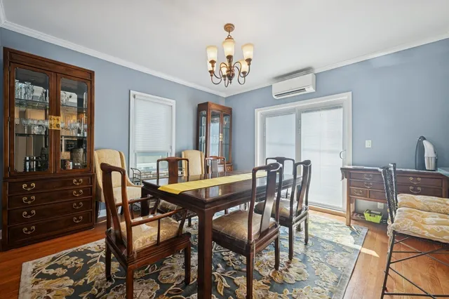 a view of a dining room with furniture and chandelier
