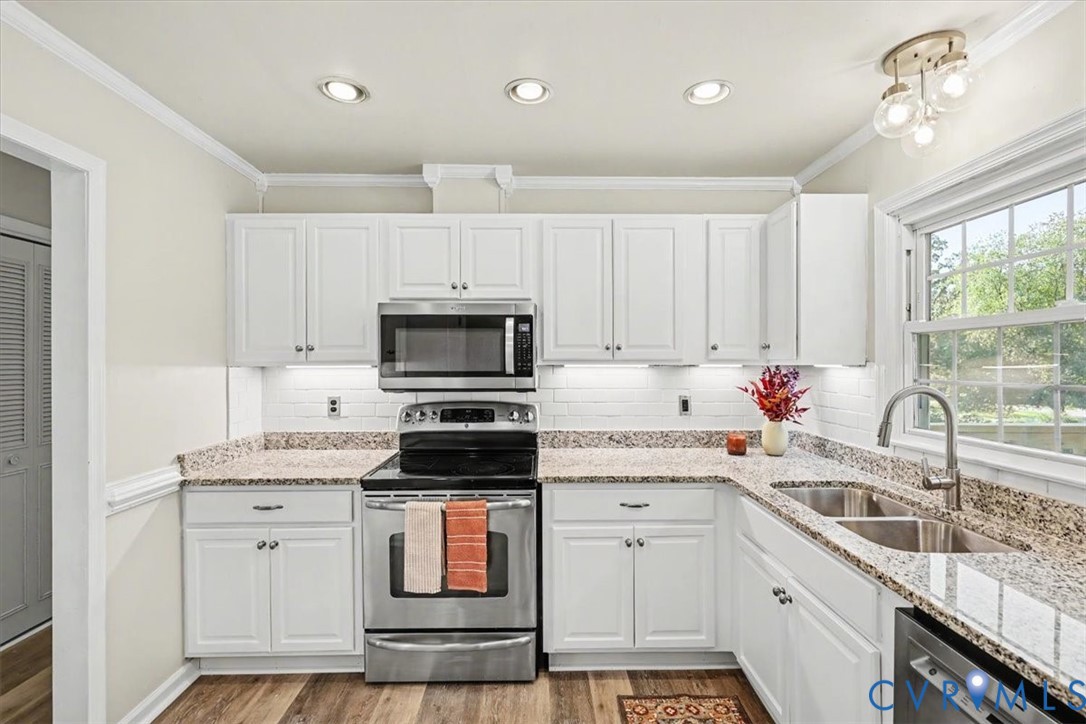 9737 Graves Road Petersburg, VA 23803 - Photo 4 of 41 Kitchen featuring white cabinetry, wood-finish flo