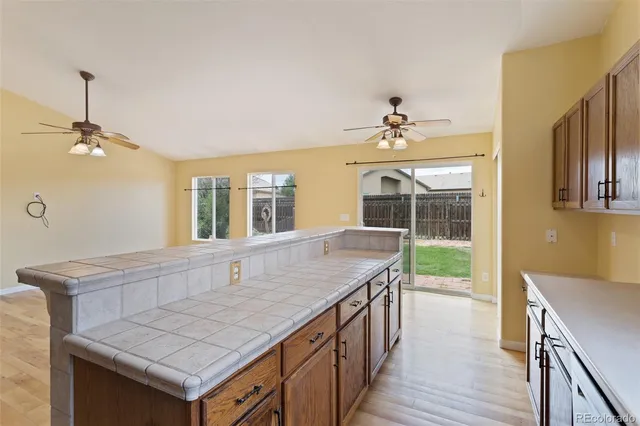 a kitchen with stainless steel appliances granite countertop a sink and a refrigerator