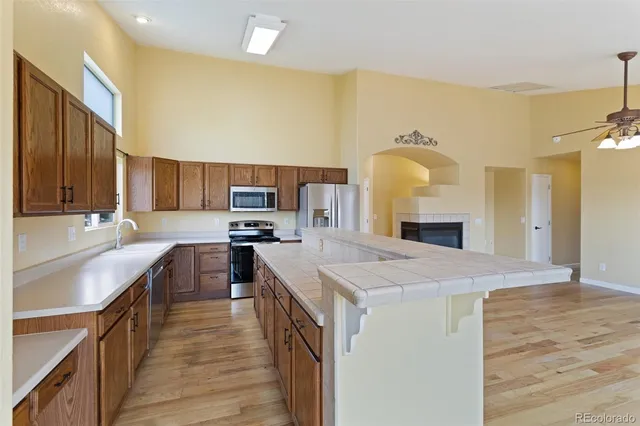 a large kitchen with kitchen island a sink stainless steel appliances and cabinets