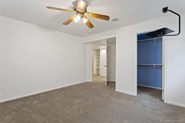 a view of an empty room with a ceiling fan