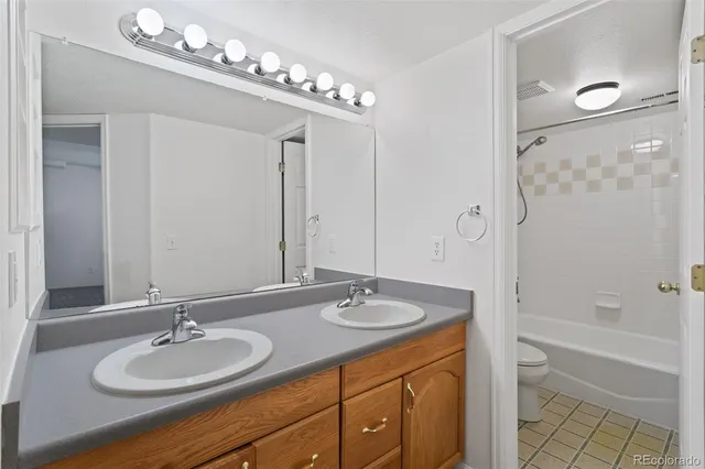 a bathroom with a granite countertop sink a mirror and a bathtub