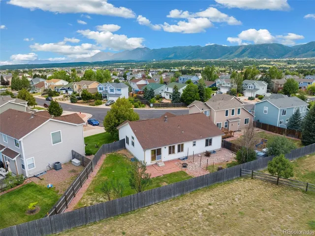 an aerial view of residential houses with outdoor space and street view