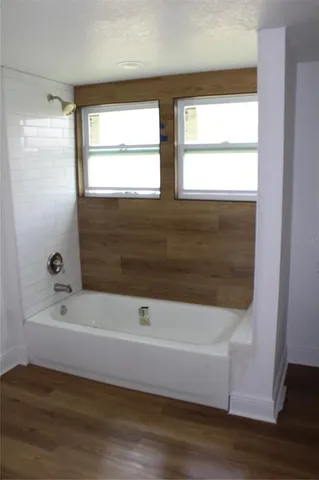 a bathroom with a bathtub and a shower