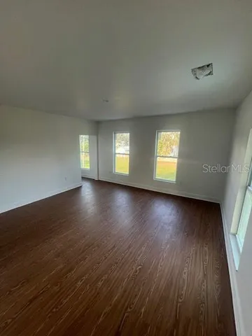 a view of a room with wooden floor and city view