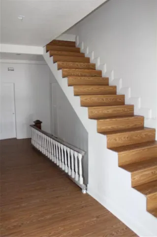 a view of an empty room and wooden floor