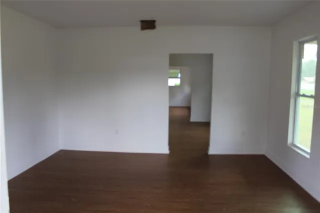 a view of a room with wooden floor and window