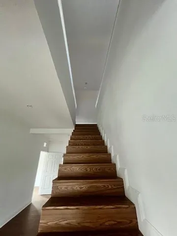 a view of room with hardwood floor and window
