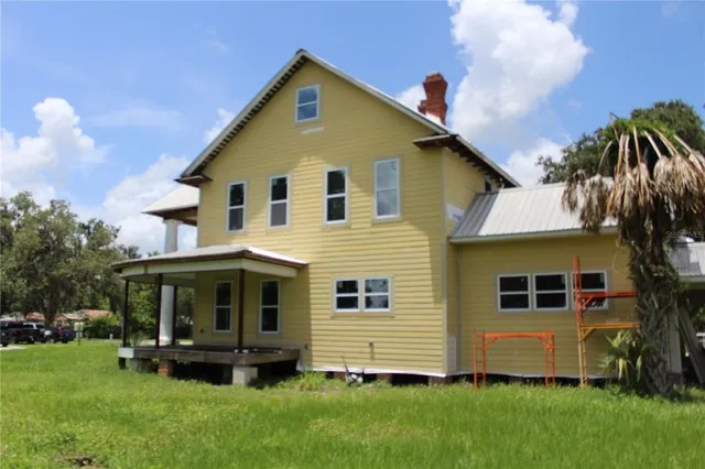 a front view of a house with a garden and plants