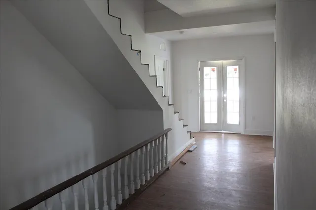 a view of a hallway with wooden floor and entryway