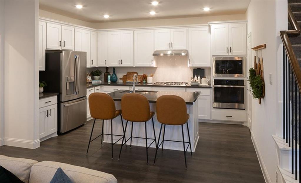 3116 Winecup Road Celina, TX 75009 - Photo 4 of 17 a kitchen with stainless steel appliances a refrigerator stove microwave and cabinets