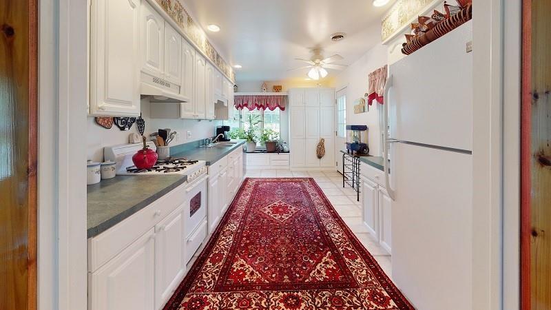 23982 Middle Road Cambridge Springs, PA 16403 - Photo 19 of 25 a hallway with a white stove top oven and a refrigerator