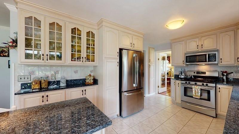 23982 Middle Road Cambridge Springs, PA 16403 - Photo 5 of 25 a kitchen with stainless steel appliances granite countertop a refrigerator and a stove top oven