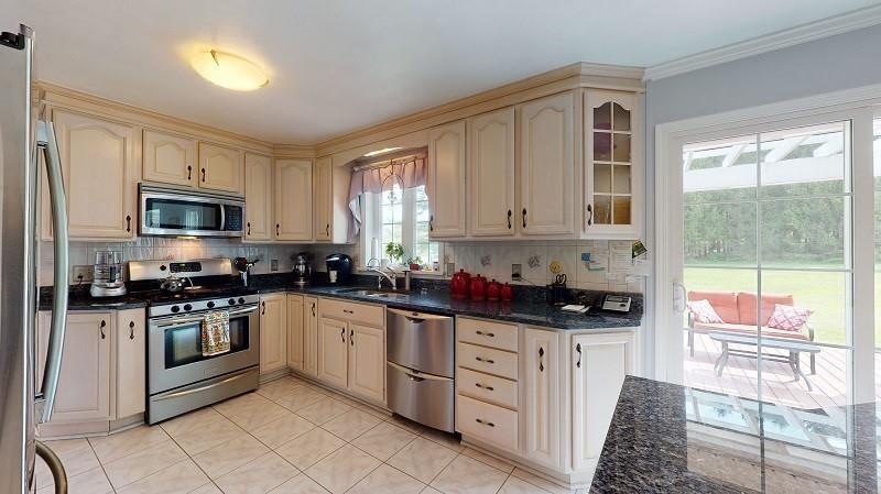 23982 Middle Road Cambridge Springs, PA 16403 - Photo 6 of 25 a kitchen with granite countertop a stove sink and cabinets