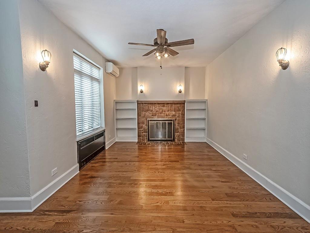 1035 Washington Road Pittsburgh, PA 15228 - Photo 11 of 44 an empty room with wooden floor fireplace and windows