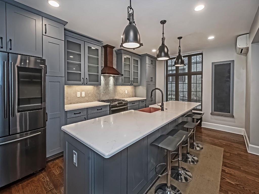 1035 Washington Road Pittsburgh, PA 15228 - Photo 13 of 44 a kitchen with a table chairs refrigerator and microwave