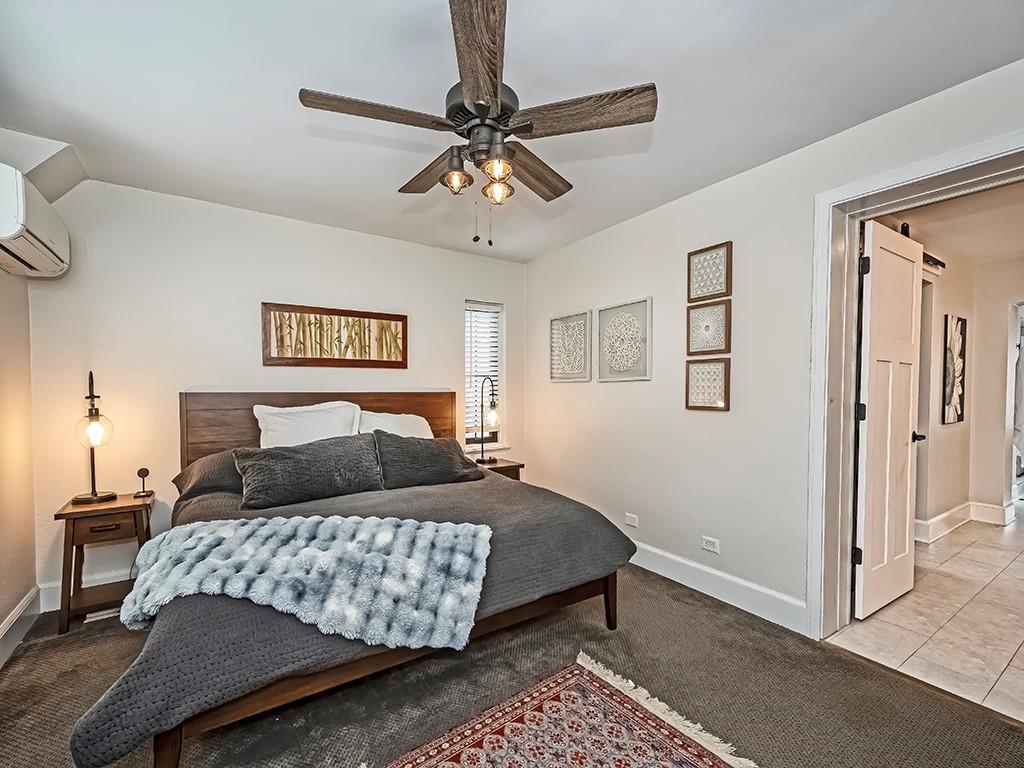 1035 Washington Road Pittsburgh, PA 15228 - Photo 21 of 44 a bedroom with a large bed and a chandelier