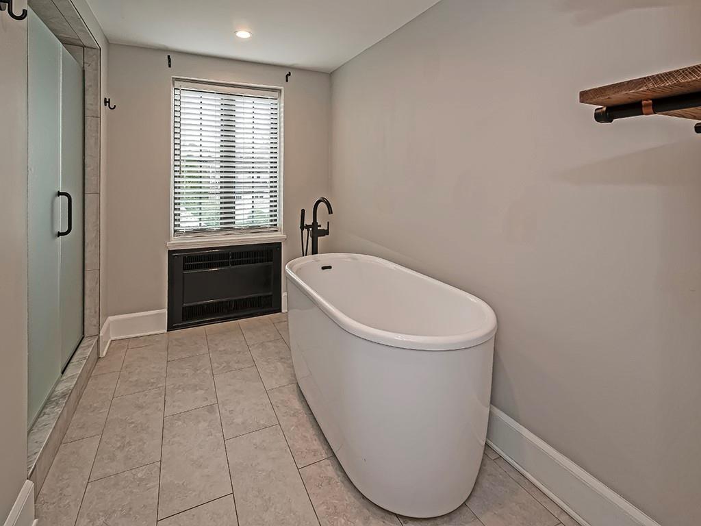 1035 Washington Road Pittsburgh, PA 15228 - Photo 23 of 44 a white bath tub sitting in a bathroom next to a window