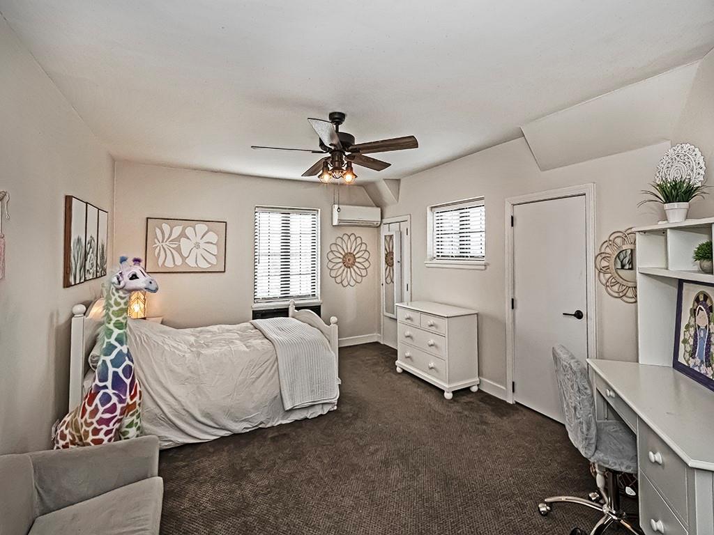 1035 Washington Road Pittsburgh, PA 15228 - Photo 26 of 44 a spacious bedroom with a bed and a chandelier