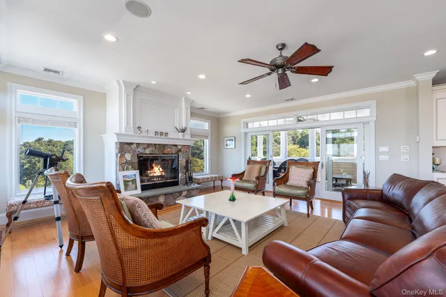 a living room with furniture a fireplace and a chandelier