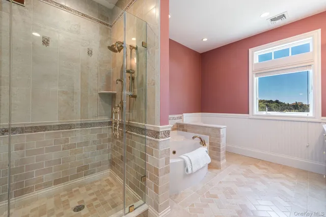 a bathroom with a bathtub and shower