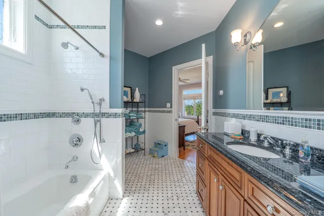 a bed sitting in a spacious bedroom next to a window