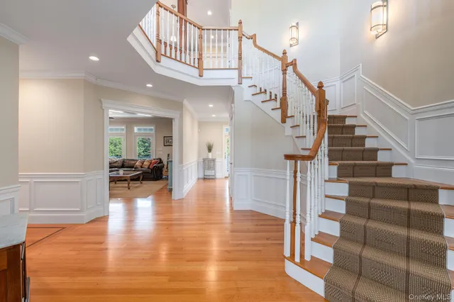 a view of entryway and hall with wooden floor