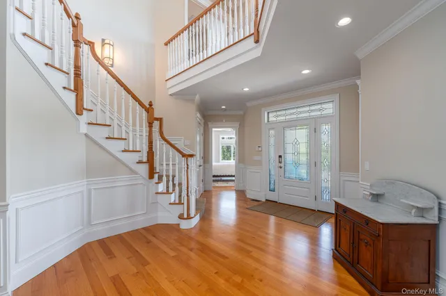 a view of entryway and hall with wooden floor