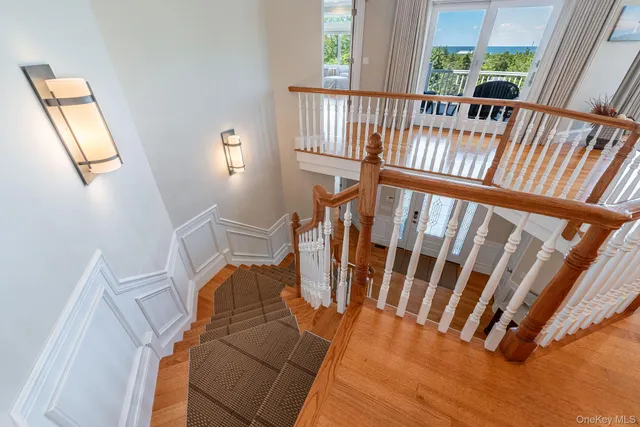 a view of entryway with wooden floor and windows