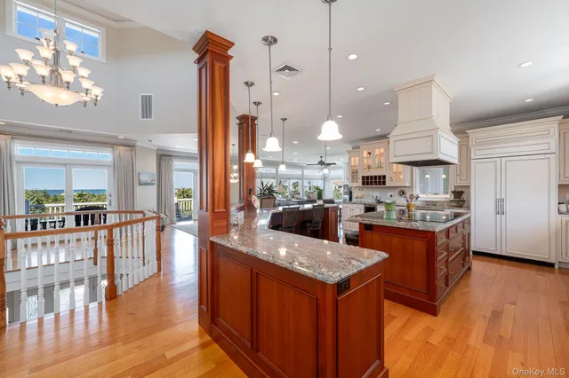 a kitchen with stainless steel appliances granite countertop a sink a stove and a wooden floors