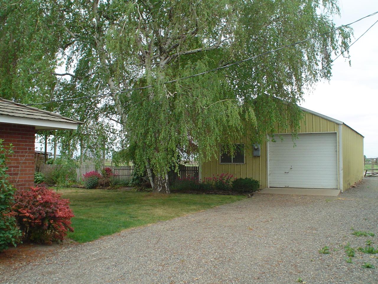 140 South McLean Road Sunnyside, WA 98944 - Photo 3 of 6 front view of a house with a yard and an trees