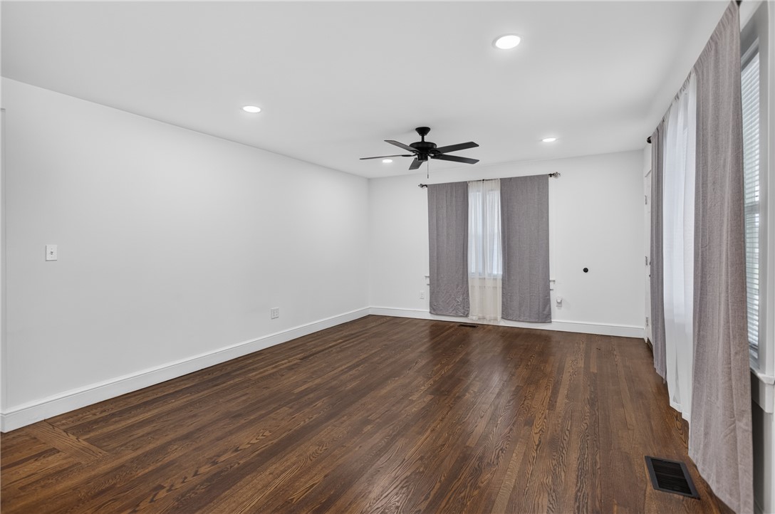 115 Pelfrey Street Seneca, SC 29672 - Photo 3 of 46 Rich hardwood flooring stretches across this naturally illuminated space, complemented by recessed lighting and a ceiling fan for comfort.