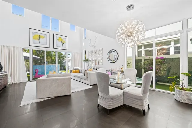 a living room with furniture and a chandelier