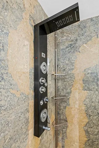 a bathroom with a shower and a mirror