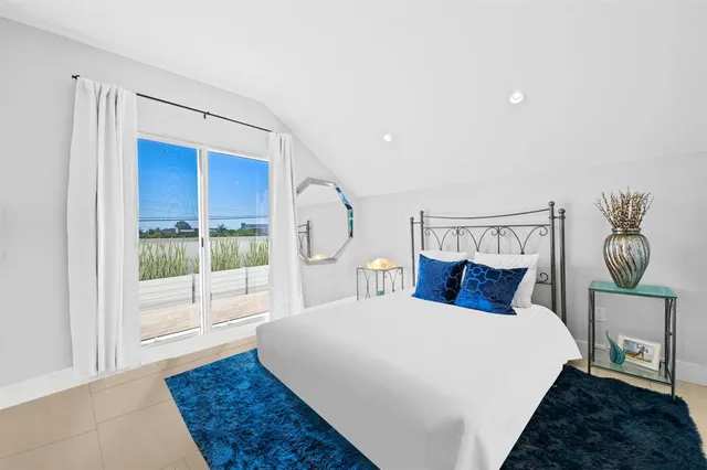 a bedroom with a large bed and a window