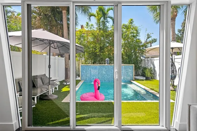 a view of swimming pool from a living room